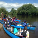 Group of canoes packed and ready to leave on river trip
