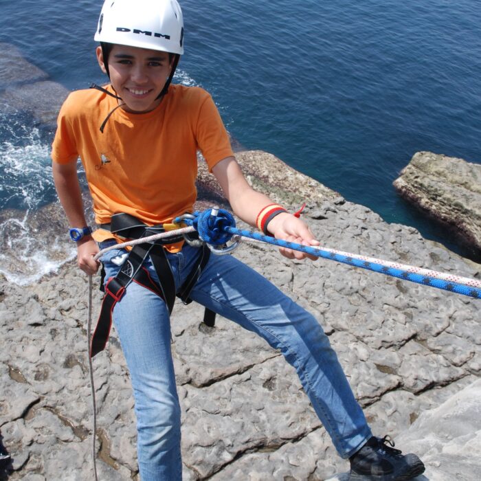 Schoolboy abseiling at Dancing Ledge