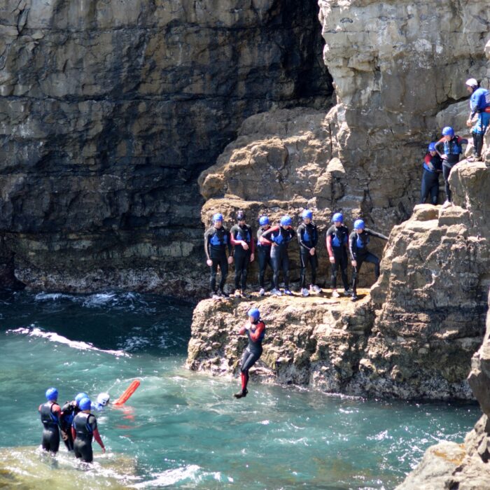 Stag group coasteering one man jumping into the sea