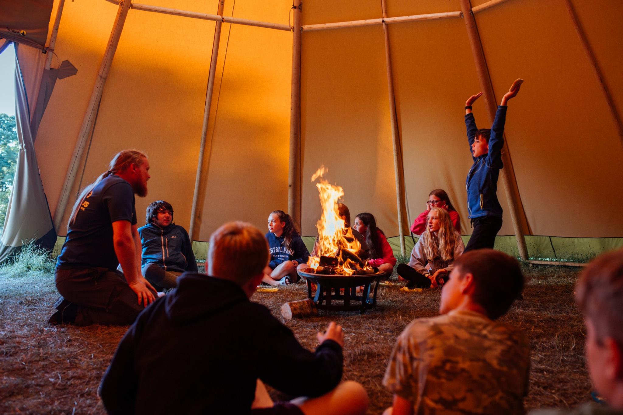 Tipi time around the fire pit discussing the days events