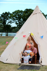 Family in tipi tent at Camp Cleavel