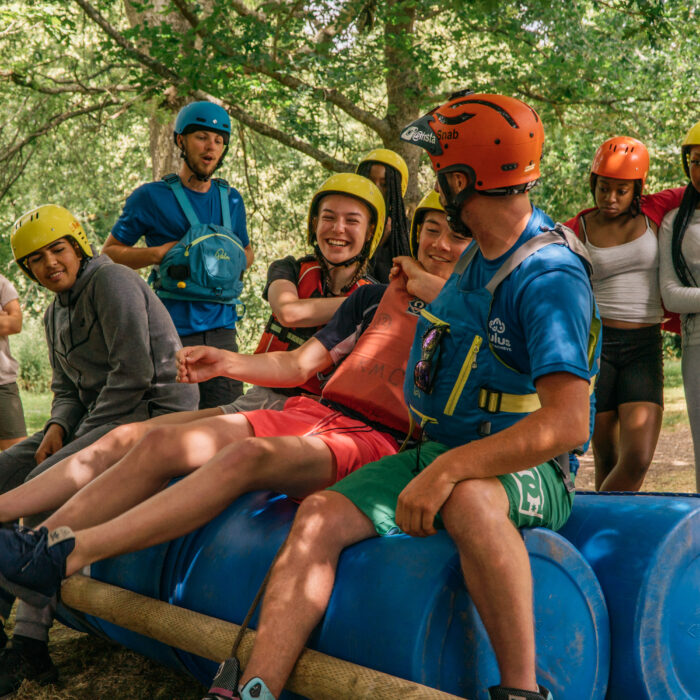 students and staff laughing on raft