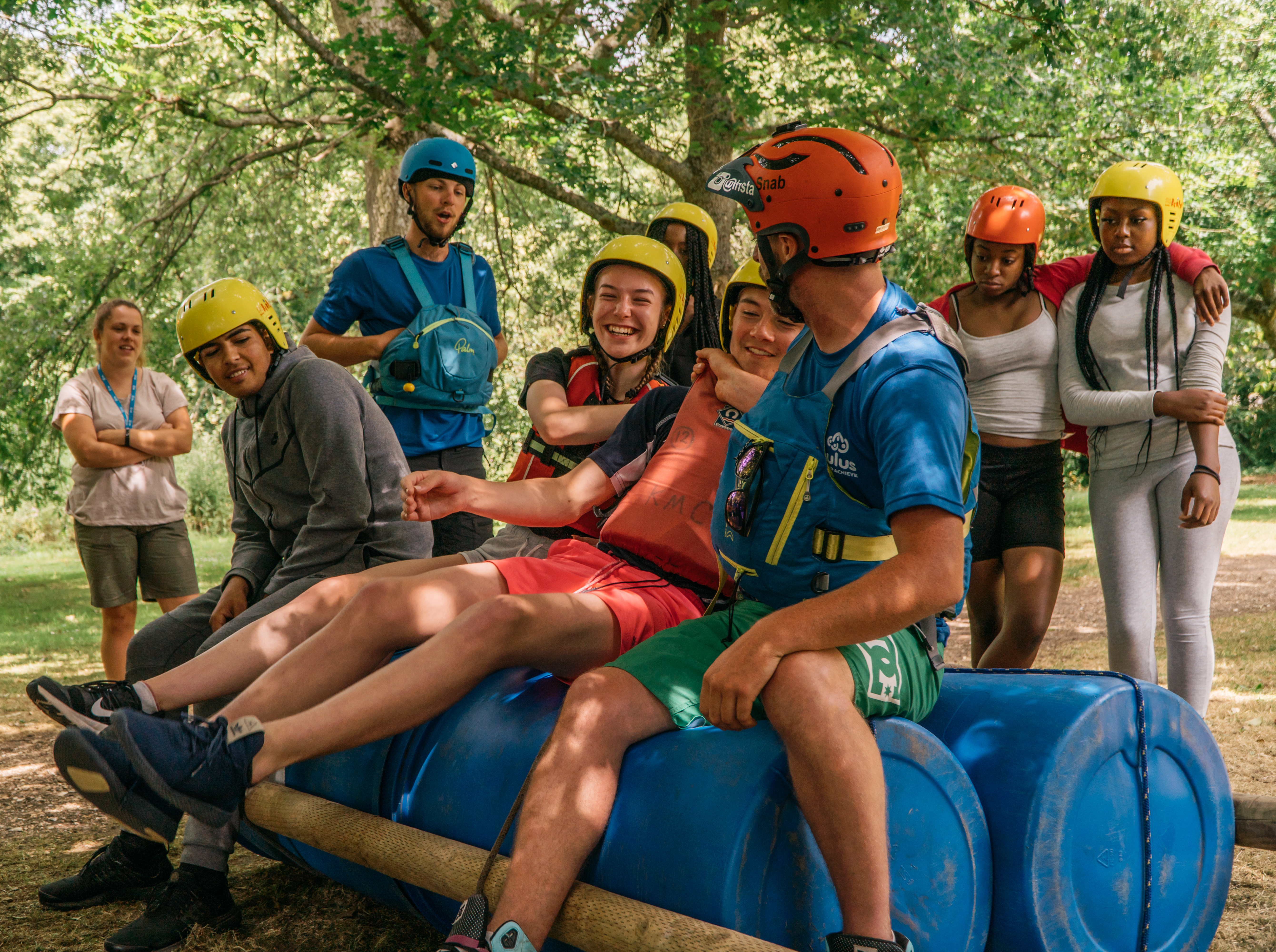 students and staff laughing on raft