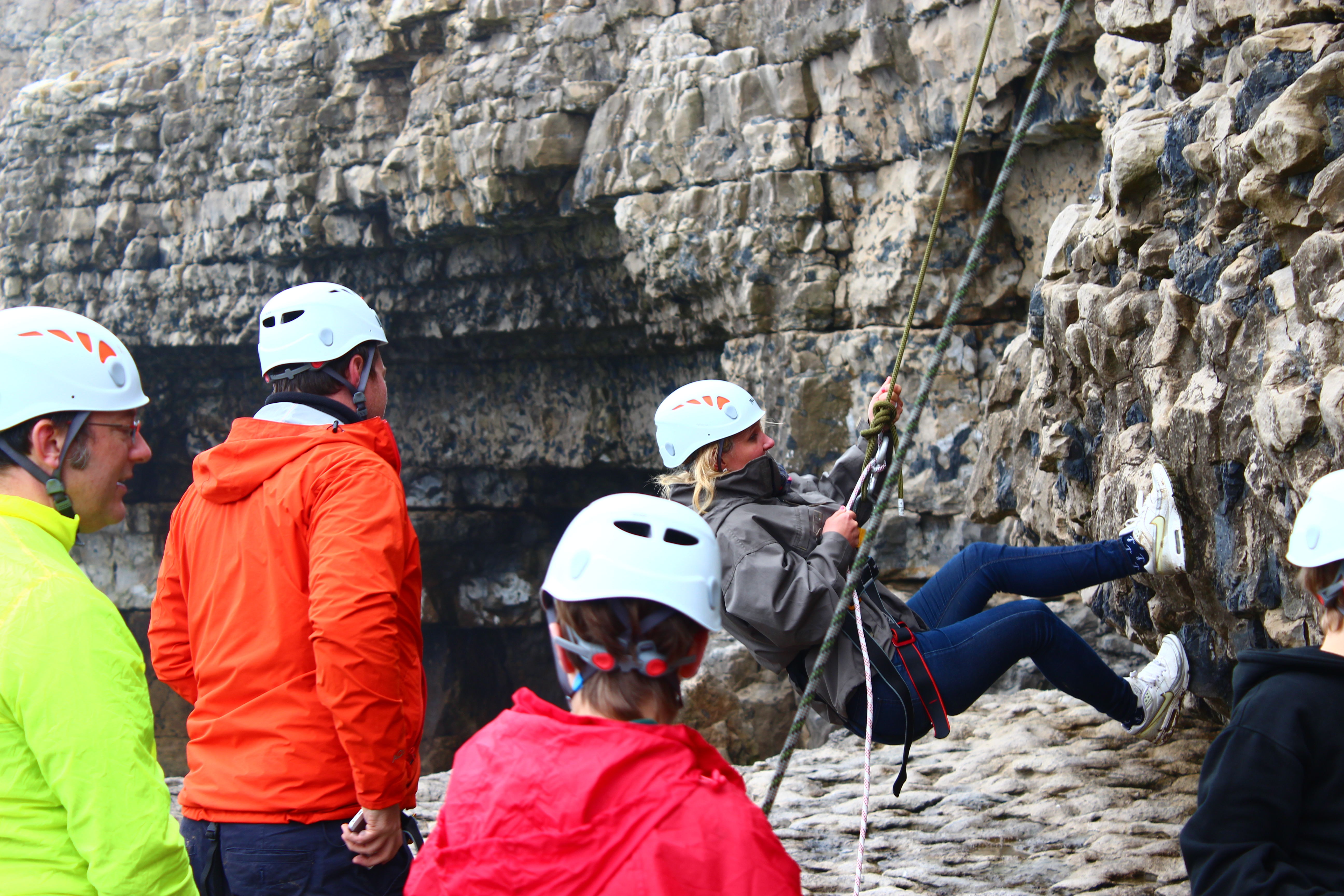 woman abseiling down a cliff