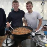 Two boys cooking for the Duke pow Edinburgh residential team