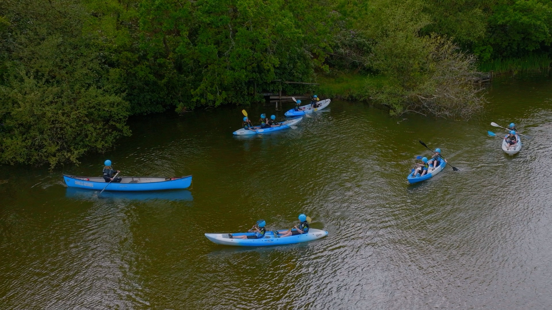 students kayaking on lake